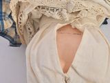 a doll that has a dress on it ' s back