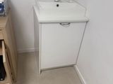 a small kitchen with a sink and a cabinet in it