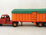 a toy truck with a trailer attached to it ' s back