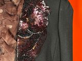 a close up of a jacket and tie on a mannequin mannequin