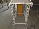 a metal table with a tray on it in a room