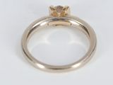 a close up of a gold ring with a diamond on top of it