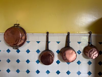 pots and pans hanging on the wall in the kitchen