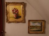 a painting on the wall above a bed in a room