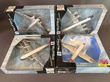 three boxed boxes of model airplanes sitting on top of a table