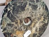 a black and white marble clock on a white table