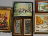 many framed pictures on the wall of a room