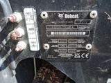 a close up of a black motorcycle with a number plate on it