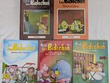 plusieurs livres pour enfants sont alignés sur une surface blanche