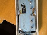 a broken cell phone sitting on top of a desk next to a keyboard