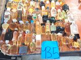 many bottles of alcohol sitting on a table with a price tag