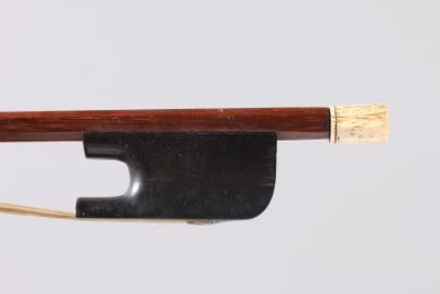 an image of a violin bow with a wooden stick sticking out of it