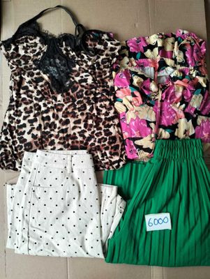 trois vêtements posés par terre à côté d'un sac