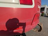 a shadow of a person on the back of a red truck