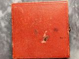 a red book with a hole in it on a table