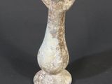 a small vase that is sitting on a black surface