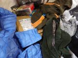 a pile of clothing that is sitting on a bed