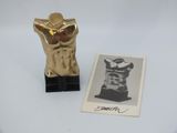an old photo of a gold statue next to a picture of a man ' s torso