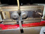an image of a machine that is working on a piece of metal