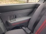 a seat in the car with a red stripe on it