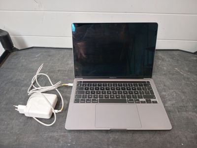 un ordinateur portable posé sur une table avec un chargeur