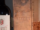 a bottle of wine sitting next to a wooden box