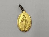 a gold medal with the image of jesus on it