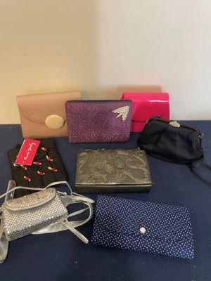 many different purses on a table with a blue table cloth
