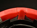 a close up of a red and black helmet with a black visor