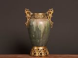 a vase that is sitting on a table with a black background