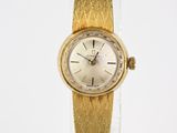 an image of a woman ' s wrist watch with a gold band