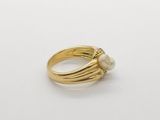 an image of a gold ring with pearls on it