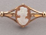 an image of a close up of a gold and white broochle broochle