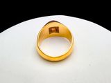 a gold ring sitting on top of a white table