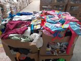 a cart full of clothes and other items in a warehouse