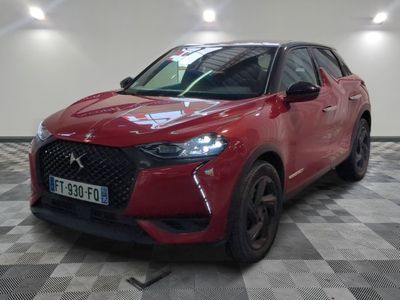 the red car is parked on a checkered floor in the garage