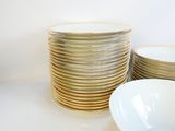 a stack of plates and bowls sitting on a table