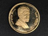 an image of a gold coin with a portrait of a man on it