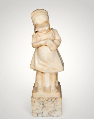 a carved ivory figurine of a woman holding a child
