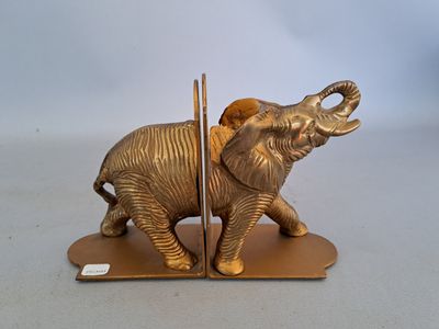 statue of an elephant with a basket on it ' s back on a stand