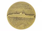 an antique gold medal with a picture of a ship on it