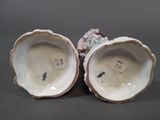 pair of porcelain figurines of shells with flowers on them