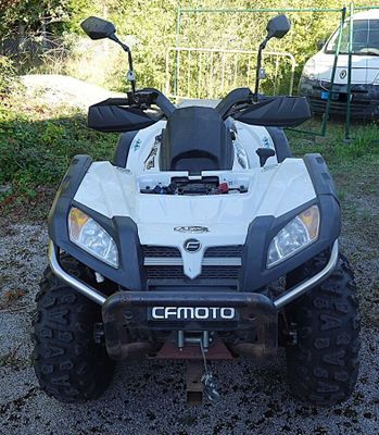 an image of a white and black atv parked in a lot