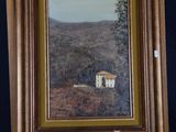 an oil painting of a house on a easel with a mountain in the background