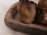 a wooden tray with two vases and a bag on it