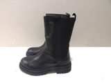 the black boots are lined up on a white surface
