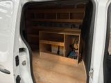 a white van with open doors in a garage