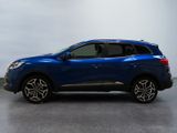 the blue suv is parked in a room with a gray floor