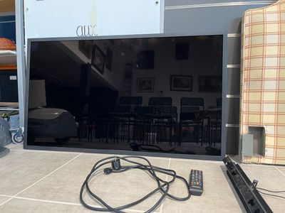 a flat screen tv sitting on the floor in the living room