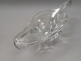 a clear glass bowl on a table with a white background